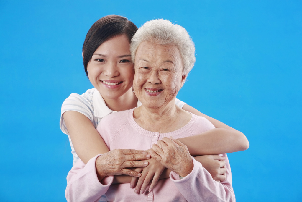 Woman hugging senior woman from the back